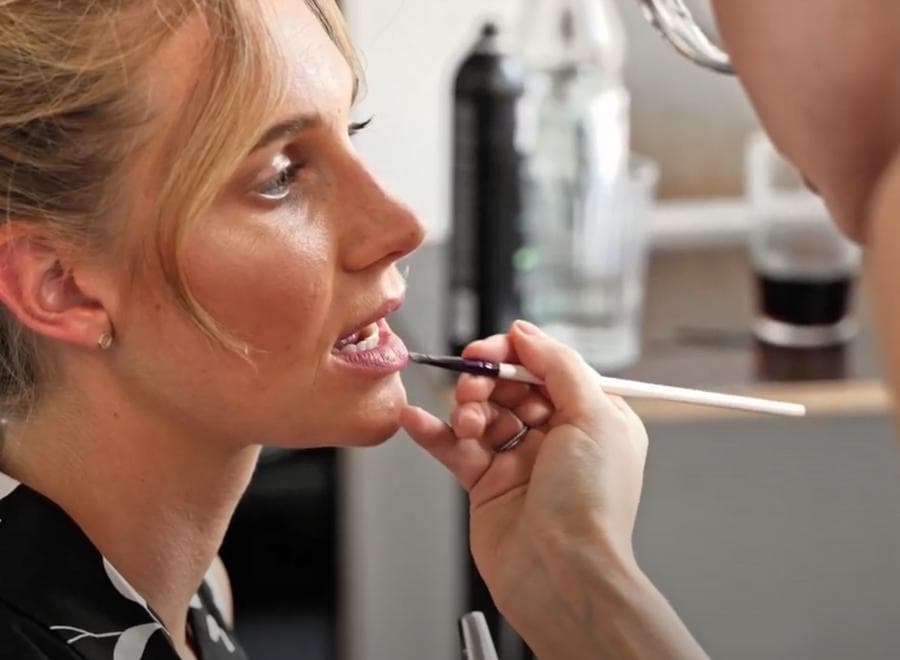 A model getting her makeup done